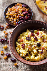 Sweet millet porridge with raisins and dried cranberries