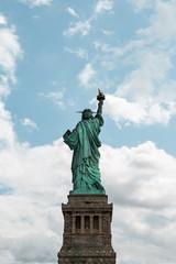 Obraz premium New York City / USA - AUG 22 2018: The statue of liberty back view in clear blue sky