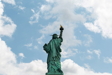 Fototapeta premium New York City / USA - AUG 22 2018: The statue of liberty back view in clear blue sky