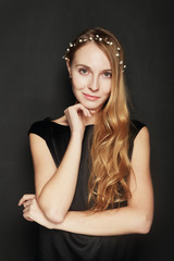 Fototapeta premium Beautiful young woman portrait on black background