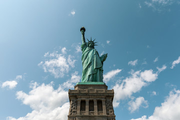 Fototapeta premium New York City / USA - AUG 22 2018: The statue of liberty back view in clear blue sky