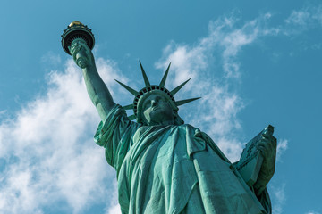 Fototapeta premium New York City / USA - AUG 22 2018: The statue of liberty back view in clear blue sky