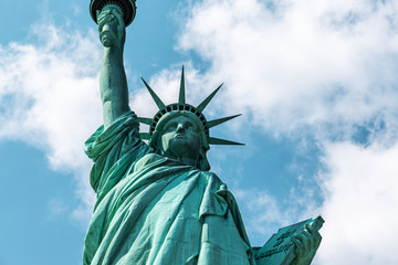 Fototapeta premium New York City / USA - AUG 22 2018: The statue of liberty back view in clear blue sky
