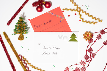 letter of red paper and a white envelope to Santa Claus on a white background, around the Christmas...