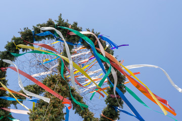 Colorful german maypole in front of blue sky