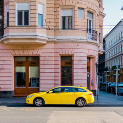 Fototapeta na wymiar Yellow car parked on the street