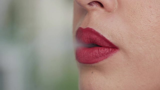 4K Footage. Young sexy business woman smoking a cigarette. Close Up.