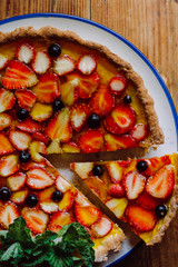 Homemade pies with jam and glass of milk on on an vintage wooden table