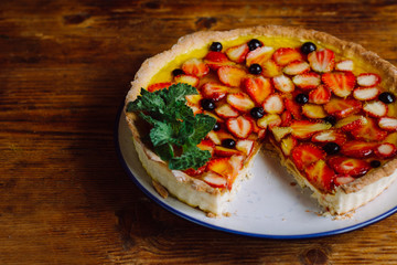 Homemade pies with jam and glass of milk on on an vintage wooden table