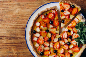 Homemade pies with jam and glass of milk on on an vintage wooden table