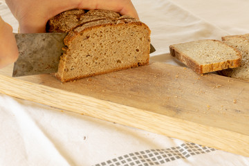 hands slicing home-made bread