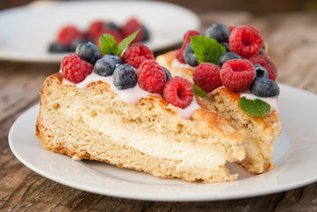 Homemade cheesecake with fresh berries and mint for dessert - healthy organic summer dessert pie cheesecake.
