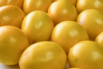 Ripe yellow lemons on white background, texture, close-up.