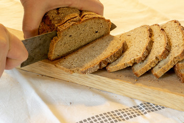 hands slicing home-made bread