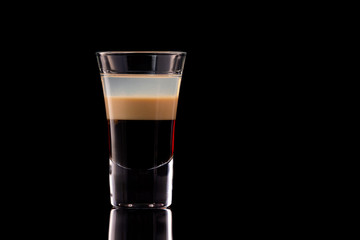 B 52 alcohol layered shooter cocktail isolated at black background.