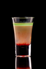Hiroshima alcohol layered shooter cocktail isolated at black background.