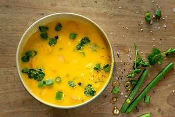 Creamy pumpkin soup in a blue bowl, close up.