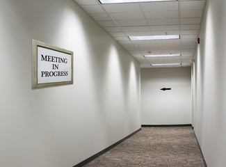 meeting in progress sign in hallway