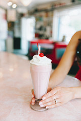strawberry milkshake on a counter in a diner