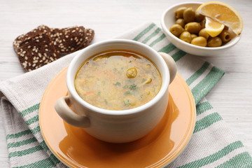 Vegetarian soup with olives and rye crackers