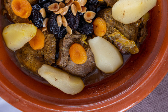 Bowl with potato, meat and dried fruit