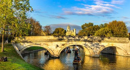 tourists on punt trip (sightseeing with boat) along River Cam near Kings College in the city of Cambridge, United Kingdom