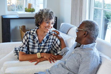 African American Senior Couple laughing and having a good time together at home