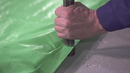 preparation of the eyelet on the plastic tent close up