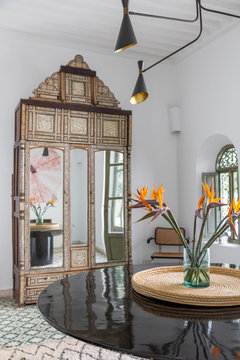 An armoire and table in a dining room