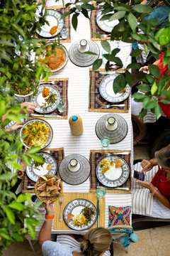 People gathered together at a table eating food