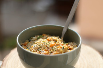 Bowl of bulgur wheat, roasted pumpkin, feta cheese and parsley salad. Selective focus.