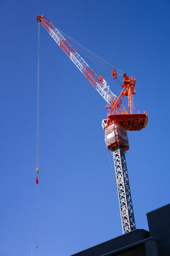 Red Construction Crane With Clear Blue Sky