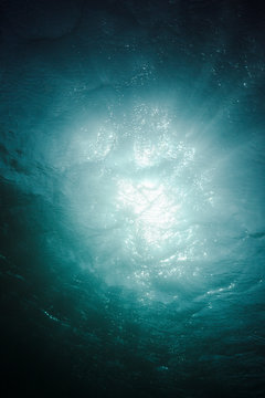 Sunlight and wind moving over the sea seen from underwater