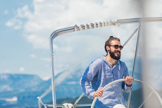 Skipper Holding Sailboat Helm