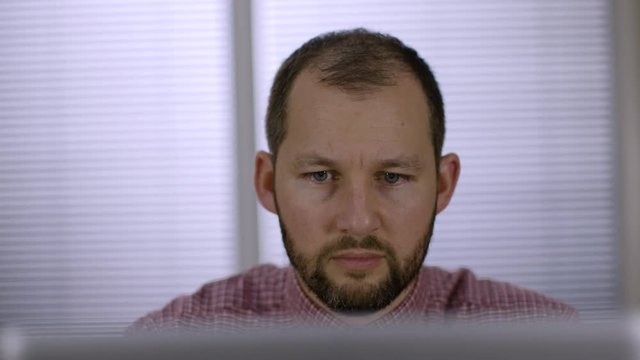 Office worker speaking to a colleague on a video conference