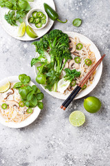 Vegetarian traditional Vietnamese soup Pho bo with herbs, rice noodles, broccolini, bok choy, bean sprouts, mushrooms. Vietnam national dish. Asian food concept.