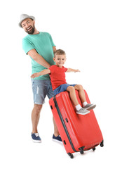 Man and his son playing with suitcase on white background. Vacation travel