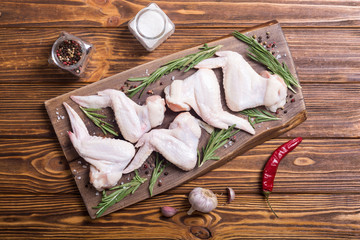 Chicken raw wings with rosemary , garlic , pepper and salt