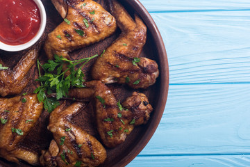 Grilled chicken wings with tomato sauce