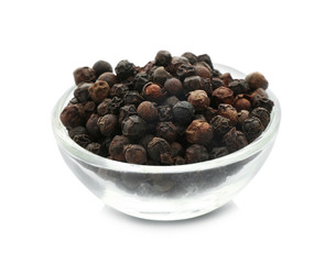 Glass bowl with black pepper grains on white background