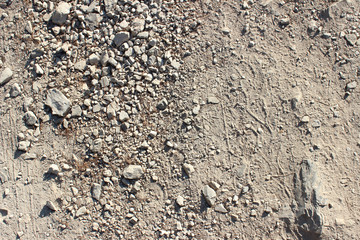 Dirt road stones markings tracks close up horizontal
