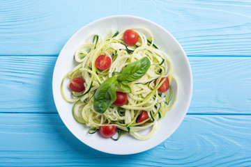 Zucchini pasta noodles with tomatoes . Healthy vegetarian food