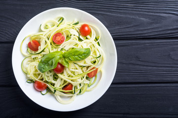 Zucchini pasta noodles with tomatoes . Healthy vegetarian food