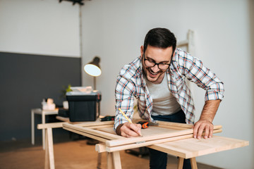 Happy young man working on DIY project.