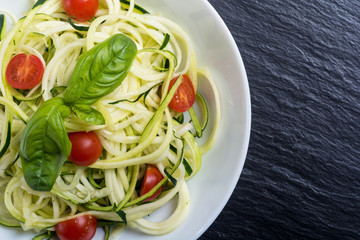 Zucchini pasta noodles with tomatoes . Healthy vegetarian food