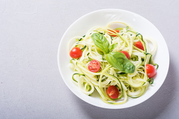 Zucchini pasta noodles with tomatoes . Healthy vegetarian food