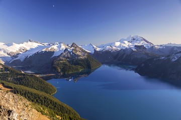 Fototapeta na wymiar Scenic Landscape View of Blue Garibaldi Lake and Distant Snowcapped Coast Mountains from Panorama Ridge in Sea to Sky Corridor between Squamish and Whistler, British Columbia Canada