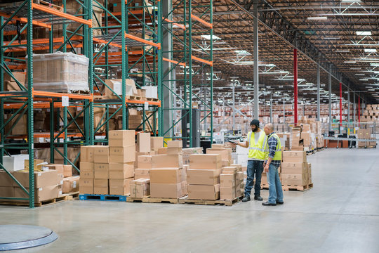 Warehouse workers in storage facilty
