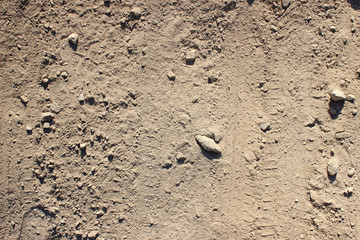 Traces markings tyre tire tracks and stones on dirt road background 