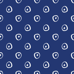 Simple abstract hand drawn white circle shapes on a navy blue background. This seamless vector pattern is perfect for textiles, fashion, gift wrapping paper, wallpaper, scrapbooking and paper.